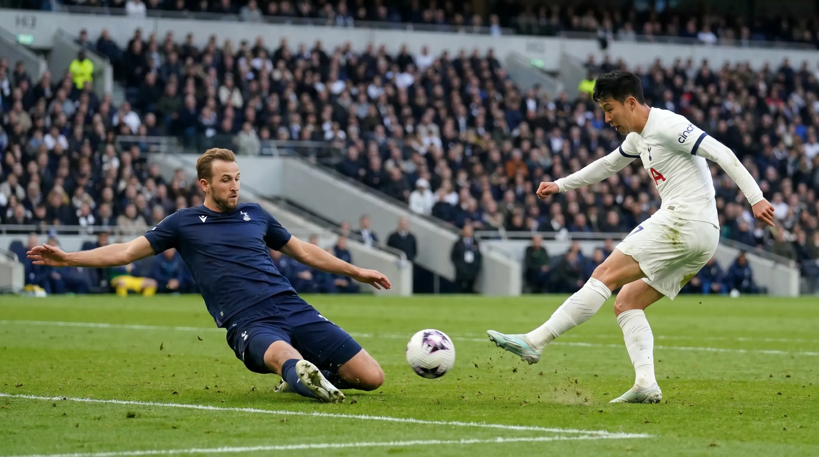 Defender blocking a low shot at the edge of the penalty area during a tight league fixture