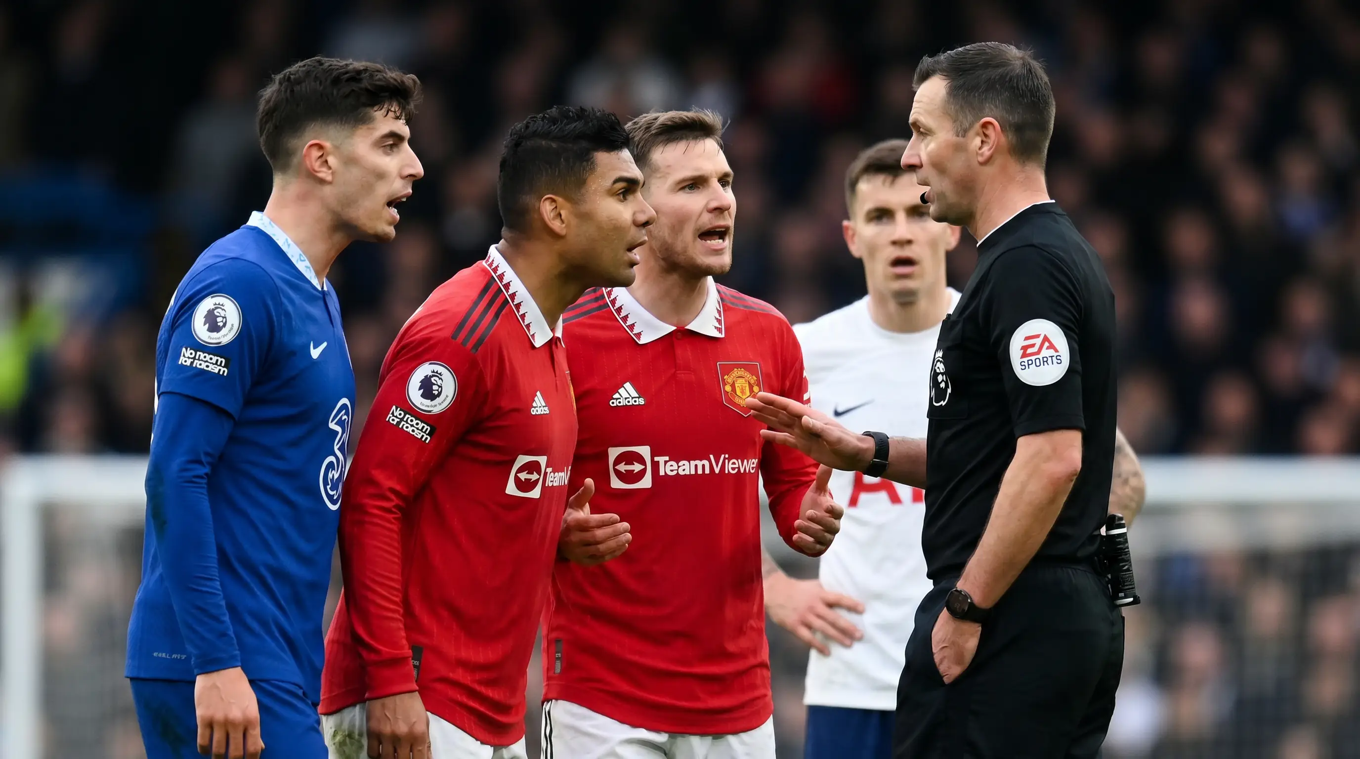 Heated exchange between players in a Premier League derby with the referee intervening