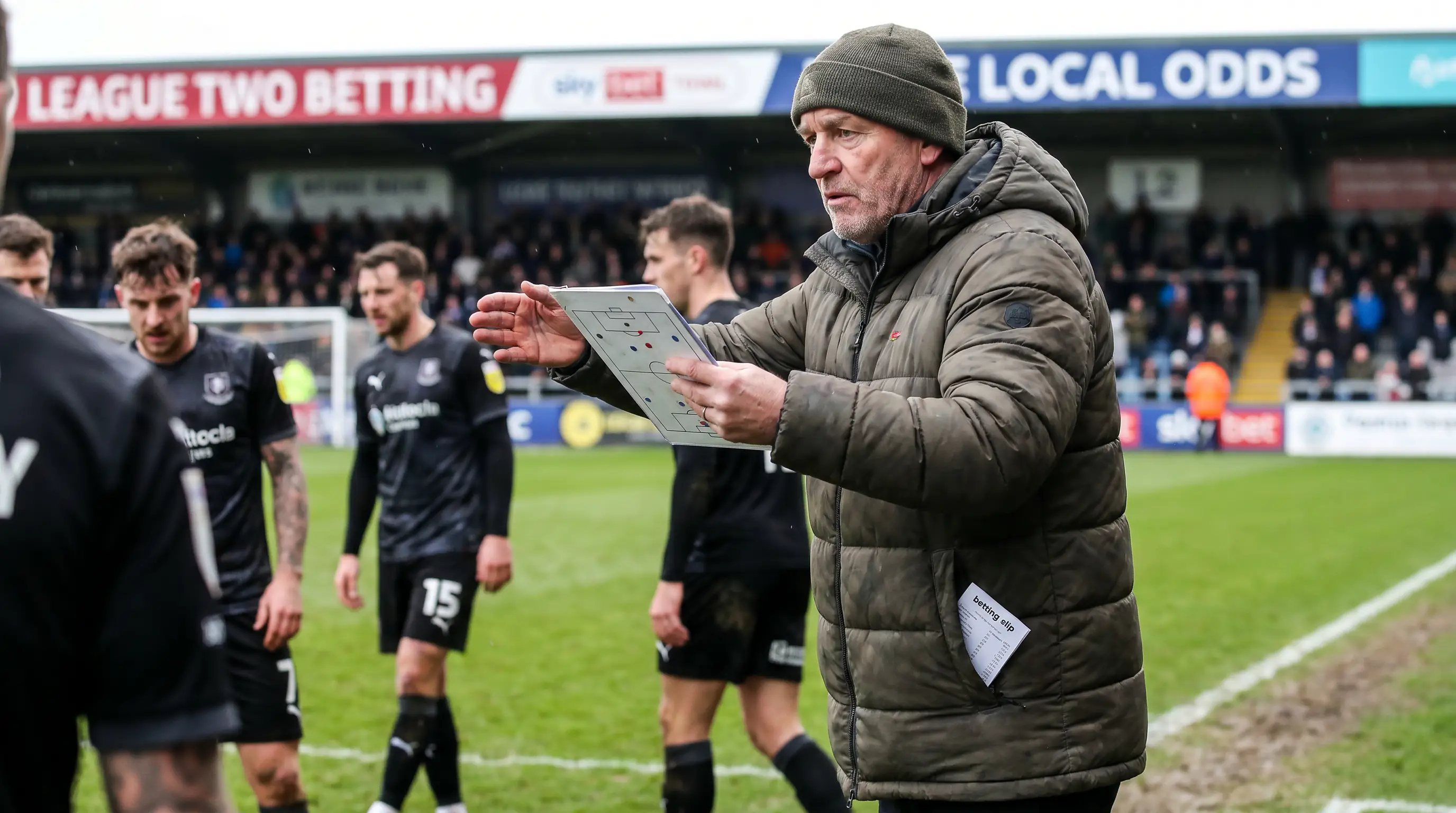 League Two manager on the touchline directing a tactically constrained side