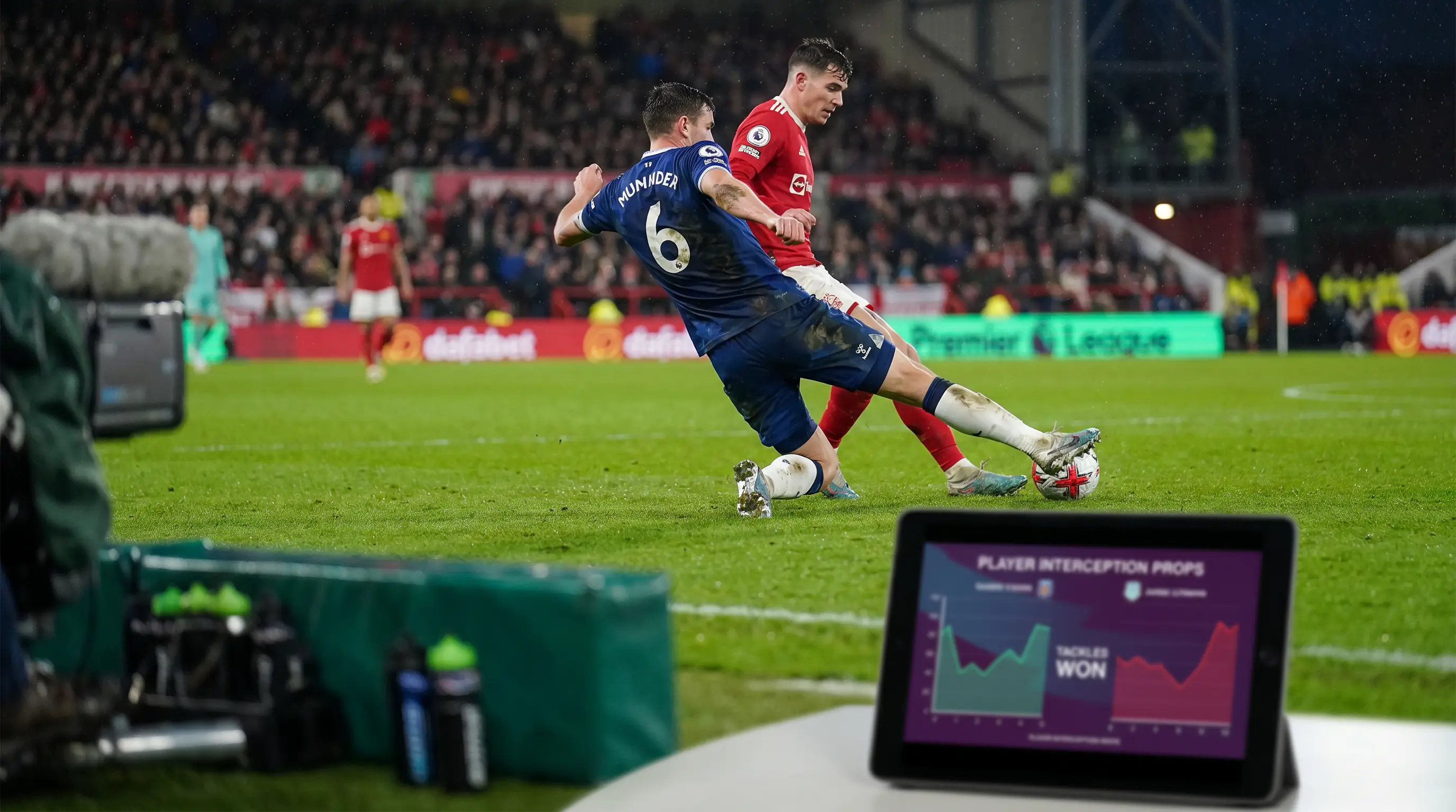 Premier League defensive midfielder making a sliding tackle in a match
